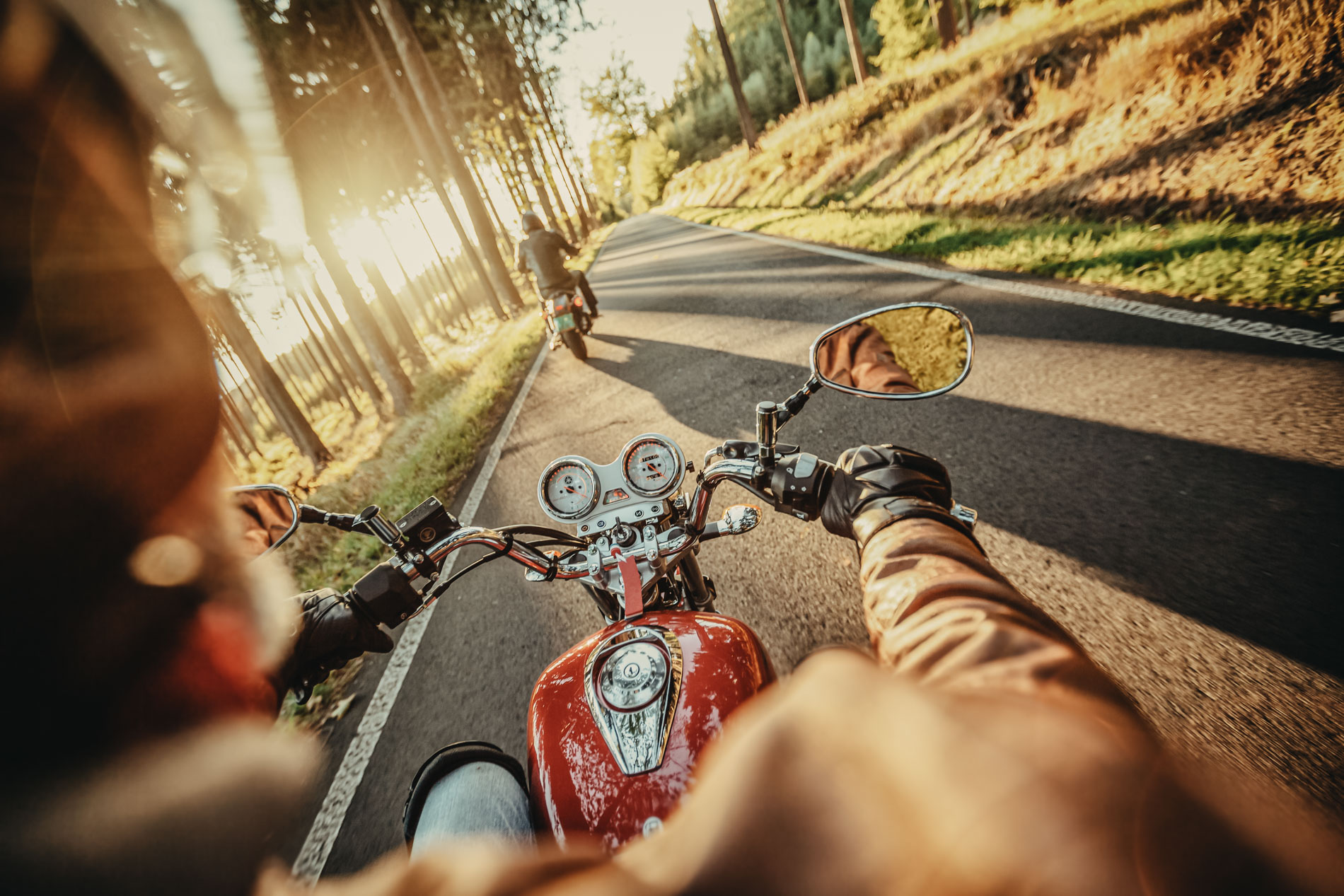 Motorcyclist riding motorbike in sunny morning